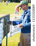 Small photo of Austin, Texas/USA - October 19, 2014: The United States Australian Football League Championship in Austin, Texas. A scorekeeper updates the information board.