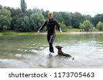 Small photo of Man in a wetsuit plays with a dog plodding on water of a lake, beach on a background. Demonstration for mass-media organized by Police Directorate. August 10,2018. Kiev, Ukraine