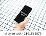 Small photo of Doomscrolling, doomsurfing, surf or scroll bad news, news is saddening, disheartening, depressing. Doomscrolling, Everything is bad concept with smartphone in female hands