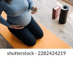 Pregnancy Workout Apps, Pregnancy Exercise Apps. Prenatal and Postnatal Workout, Pregnancy Wellness and Yoga Workouts in cell phone. Pregnant woman looking for Workout in phone