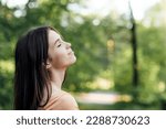 Small photo of Ways To Unplug From Technology and Be Present. Unplugging from Technology and Living a More Mindful Life. Outdoor portrait of young woman enjoying nature
