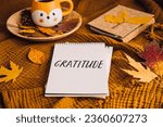 How to Practice Gratitude. Writing Autumn fall gratitude journal. Open paper notebook pages with Text gratitude and fall leaves brown bed. Notice appreciate good things, Express gratitude to yourself.
