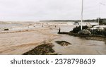 Small photo of Flooded road and muddy sea water at a Danish beach under a violent storm surge