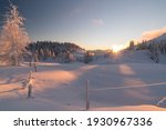 Magical white winter sunset at Dobratsch Natural Park with untouched snow and frost covered pine trees, Villach, Carinthia, Austria