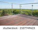 Contemporary architecture appartment balcony view with exotic cumaru wood grooved decking and glass railing