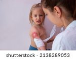 Child burn injury, burns treatment and healing, pediatrician is dressing wound on toddler arm with a sterile non-adhesive bandage