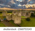 Small photo of Aerial view of Roscommon castle in Ireland, Anglo Norman stronghold with quadrangular shape with large round towers on the corners with dramatic colorful sunset sky