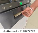 Small photo of ATM Cash withdrawal - Indian rupees in ATM. Man withdrawing the cash via ATM, business Automatic Teller Machine concept.