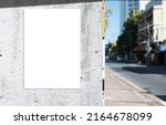 Small photo of Mockup white paper or white sticker poster displayed on a sidewalk wall. Promotion information for marketing announcements and details