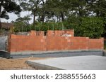building brick walls with cement and mortar in house construction site