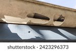 Small photo of Damaged Gutters after a hail storm with holes and impact of large hailstones waiting gutter Repair Roof Guttering