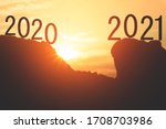 Small photo of Happy new year 2020 Go straight 2021 year, Silhouette of 2020 and 2021 year letters on the mountain with sunset light, Concept New year success
