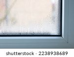 Small photo of Close up of double glazed window condensation causes by excessive moisture in the house in winter occurs when the seal between panes is broken or desiccant inside the window.