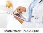 Woman Doctor Using Tablet...