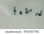 Small photo of more mounting bolts and nuts on a metallic background