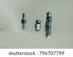 Small photo of more mounting bolts and nuts on a metallic background