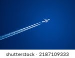 Sharp telephoto close-up of jet plane aircraft with contrails cruising from Tokyo to Boston, altitude AGL 37,000 feet, ground speed 548 knots.