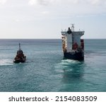 Small photo of Bridgetown, Barbados - 26 March 2022: The Cargo Ship CFS Horizon leaves Bridgetown harbour escorted by a Tug boat, as seen from