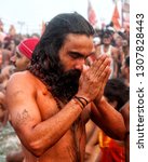 Small photo of A NAGA SADHU TAKING THE HOLY DIP IN GANGES ON THE ROYAL BATHING DAY, ALLAHABAD, INDIA - FEBRUARY 04, 2019: Highly enthused holy sadhu with hands folded in prayer in Ganges river’s Triveni Sangam.