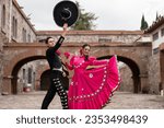Small photo of Latin couple of dancers wearing traditional Mexican dress from Guadalajara Jalisco Mexico Latin America, young hispanic woman and man in independence day or cinco de mayo parade or cultural Festival