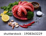 Small photo of Octopus food salad vegetable with garlic lemon chili salt coriander parsley and pepper on black plate for boiled cooked seafood, Fresh squid octopus cuttlefish dinner restaurant