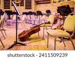 Small photo of Moscow, Russia - December, 26, 2023: During the intermission of a classical music concert. Musical instruments - cellos, bows, music stands. Moscow International House of Music-MMDM.