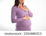 Small photo of A pregnant girl who has heartburn in her stomach. Reflux of hydrochloric acid into the esophagus. Heartburn in pregnancy.