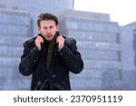 Small photo of Young man, businessman shiver tremble in coat at winter cold snowy weather outdoors