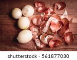 Onion peeled and skin on wooden background.