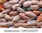 Small photo of Marrakech, Morocco - October 28, 2023: Moroccan earthquake reconstruction without post-colonial interference: stacked sacks with local cement and lime, some labeled in Tifinagh script