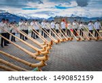 Small photo of Avry-devant-Pont, Switzerland - April 27, 2019: Ensemble of Swiss alphorn (alpenhorn, alpine horn) blowers are playing outdoor for everyone. Alpin horn is a symbol of Swiss alpine traditions