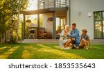 Small photo of Smiling Father, Mother and Son Pet and Play with Smooth Fox Terrier Retriever Dog. Sun Shines on Idyllic Happy Family with Loyal Pedigree Dog have Fun at the Idyllic Suburban House Backyard