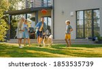 Small photo of Smiling Beautiful Family of Four Play Fetch flying disc with Happy Golden Retriever Dog on the Backyard Lawn. Idyllic Family Has Fun with Loyal Pedigree Dog Outdoors in Summer House Backyard