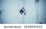 Small photo of Top View Ice Hockey Rink Arena Game Start: Two Players Face off, Sticks Ready, Referee Ready to Drop the Puck. Intense Game Wide of Competition. Aerial Drone Shot