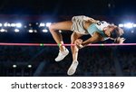 Small photo of High Jump Championship: Professional Female Athlete on World Championship Successfully Jumping over Bar. Shot of Competition on Stadium with Sports Achievement Experience. Determination of Champion.