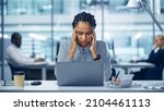 Small photo of Young Black Woman Office Worker Uses Laptop, Feels Sudden Burst of Pain, Headache, Migraine. Overworked Accountant Feeling Project Pressure, Stress, Massages Her Head, Temples. Front View Portrait