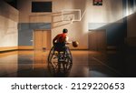 Small photo of Wheelchair Basketball Player Dribbling Ball Like a Professional, Ready to Shoot and Score Goal. Determination, Motivation of a Person with Disability Excelling at Team Sport. Back View Shot