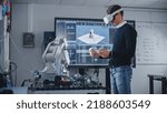 Small photo of Student Engineer Using Virtual Reality Software for His Project. Man with Headset and Controllers Studying at Modern University in Classroom. Futuristic and High Tech Concept