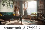 Small photo of Athletic Young Couple Exercising Together, Stretching and Doing Yoga in the Morning in Bright Sunny Room at Home. Beautiful Man and Woman in Sports Clothes Practising Different Asana Poses on the Mat.