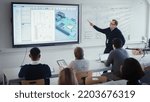 Small photo of Male Teacher Explains About Computer Motherboard Components to Students During Lesson at University. Using Interactive Whiteboard. 3D Modelling of Circuit Board for Equipment Concept.