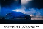 Small photo of Highway Traffic Patrol Car In Pursuit of Criminal Vehicle. Police Officers in Squad Car Chase Suspect on Road During a Misty Night. Cinematic Industrial Area. Action Scene