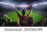 Small photo of Establishing Shot of Fans Cheer for Their Favorite Team on a Stadium During Soccer Championship Final Match. Teams Play, Crowds of Fans Celebrate Victory and Goal. Live Football Cup Tournament Concept