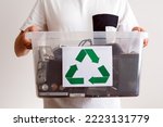 Household electrical and scrapped electronic devices in recycle container. Sorting, disposing and recycling. Waste Electrical and Electronic Equipment. Hazardous E-Waste Recycling. 