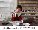 Small photo of Female artisan running small business analyzing bills and receipts while standing at table in ceramic art studio, doing pottery cost analysis, calculating fixed and variable costs of small business