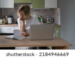Small photo of Thoughtful middle-aged woman reads created notes about found job vacancies on different sites via Internet. Mature blonde scandinavian female looks with anxious expression preparing worthy resume
