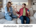 Offended upset woman feels lonely talking to husband who brushes off, does not want to resolve difficulty in relations, hides mobile phone. Exhausted from stress wife, drooping, communicates with man