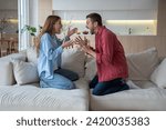 Small photo of Man and woman quarrel, yelling, arguing. Husband and wife, married couple loudly, emotionally shout at each other during violent quarrel, trying to prove their case. Guy and girl scandalize. Hysteria.