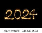 Happy new year 2024 text written hand drawn with golden Sparkle fireworks isolated on black background