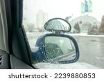 Side mirror of the car in the snow close up