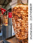 Small photo of Grilled chicken meat on a vertical rotisserie used in traditional turkish street food Doner Kebab (Shawarma or Gyros in other cultures) in Istanbul, Turkey